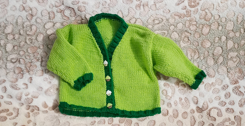 Adorable handknitted light green v-neck toddler cardigan with contrasting dark green ribbing and special cupcake buttons, perfect for your 6-9 month old.