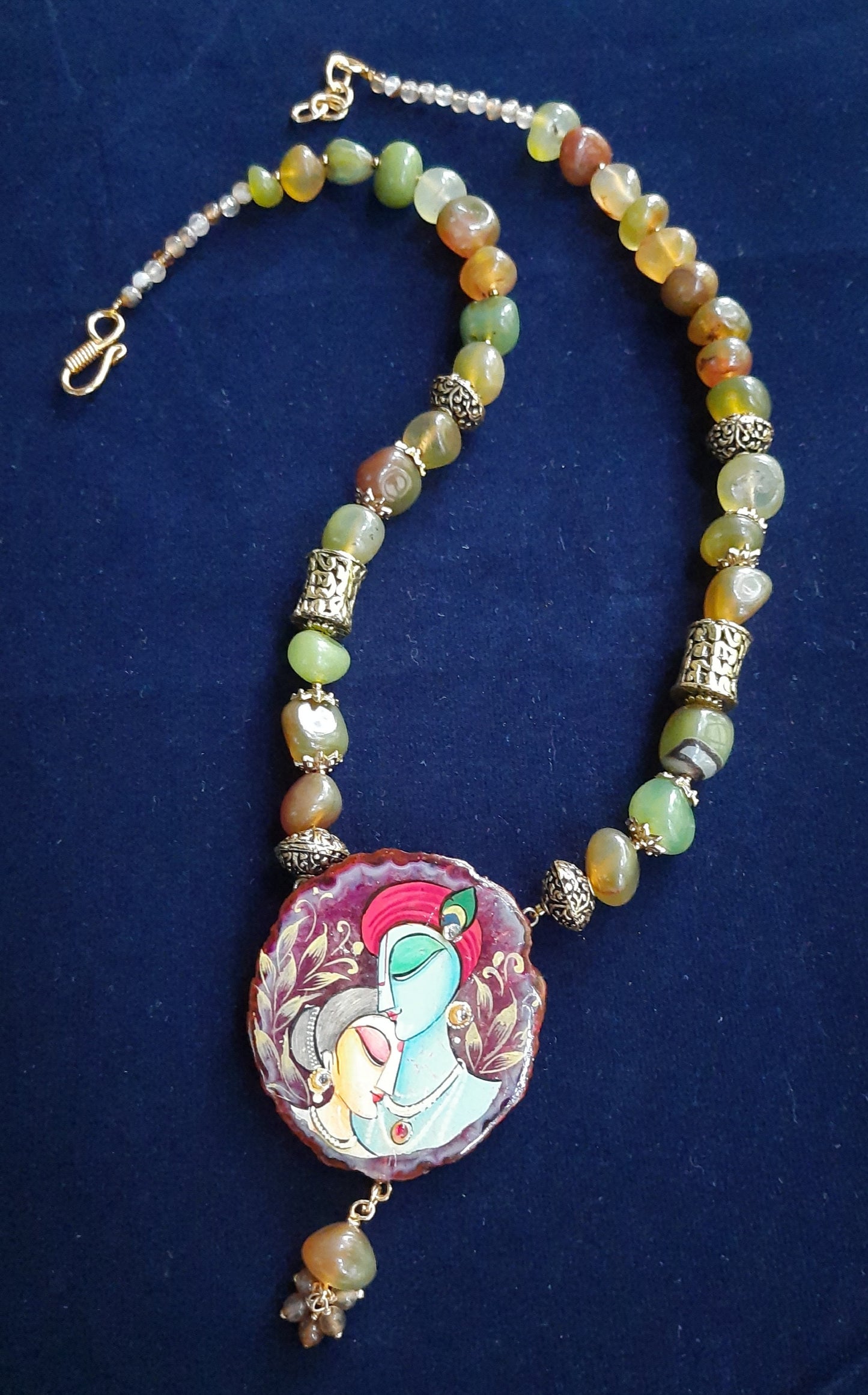 
                  
                    Enchanting mixed light green and brown agate nugget beads necklace with matching Radhakrishna pendant
                  
                