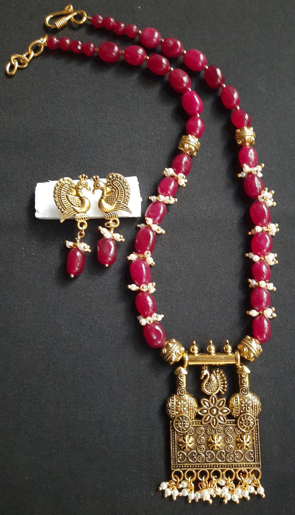 Gorgeous ruby red Dul Dul agate beads necklace with peacock pendant and matching peacock earrings.