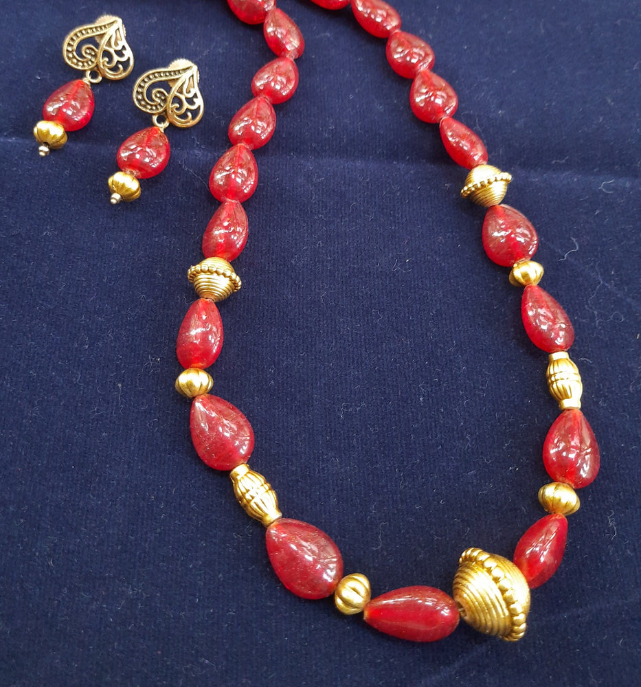 
                  
                    Ethinic red glass beads neckpiece with matching earrings.
                  
                
