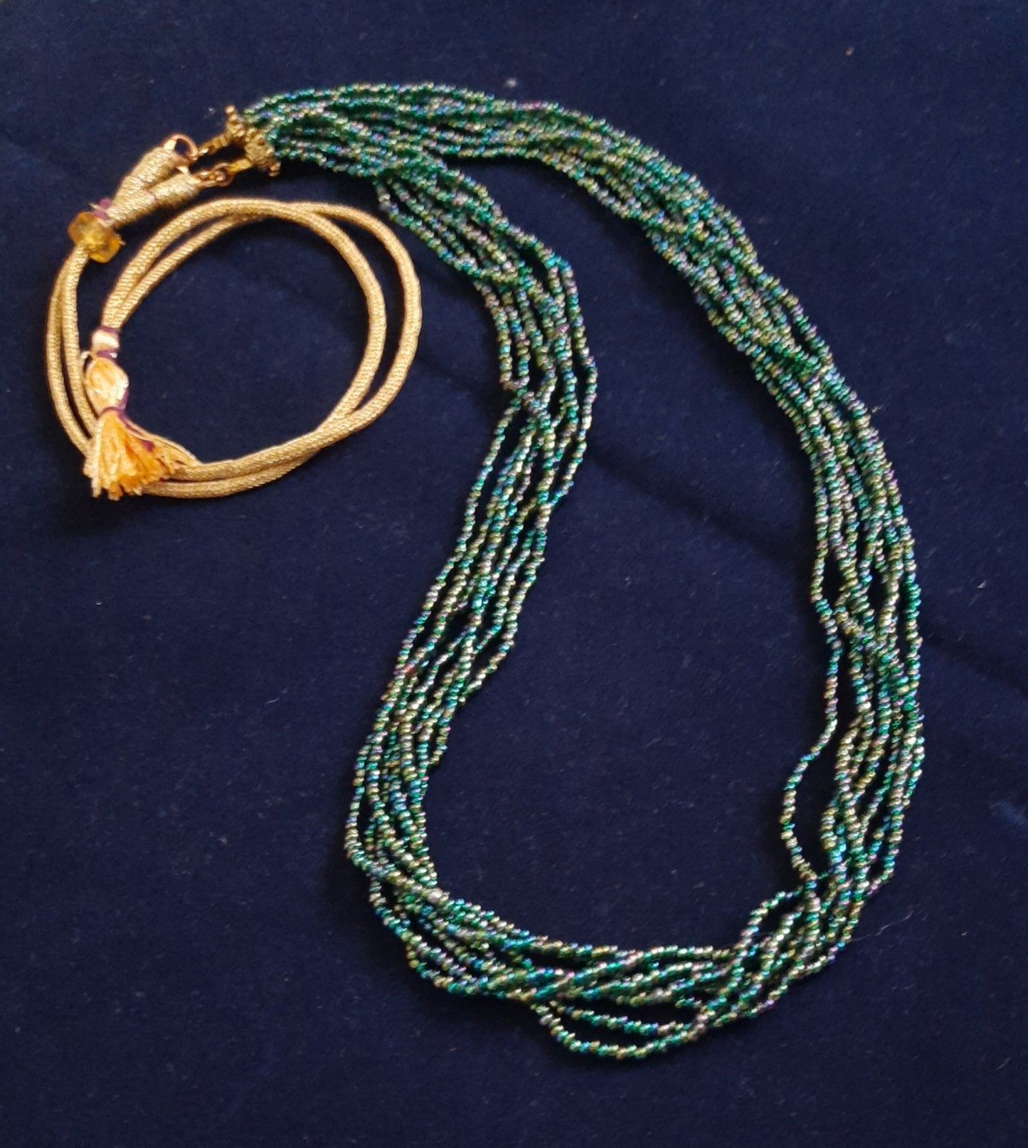 
                  
                    Glimmering green based multicolour multilayered beads mala.
                  
                