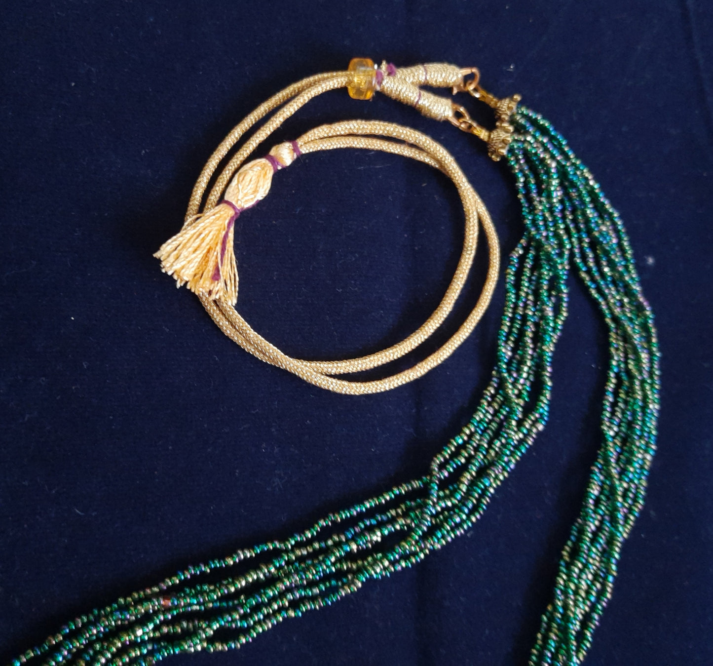 
                  
                    Glimmering green based multicolour multilayered beads mala.
                  
                