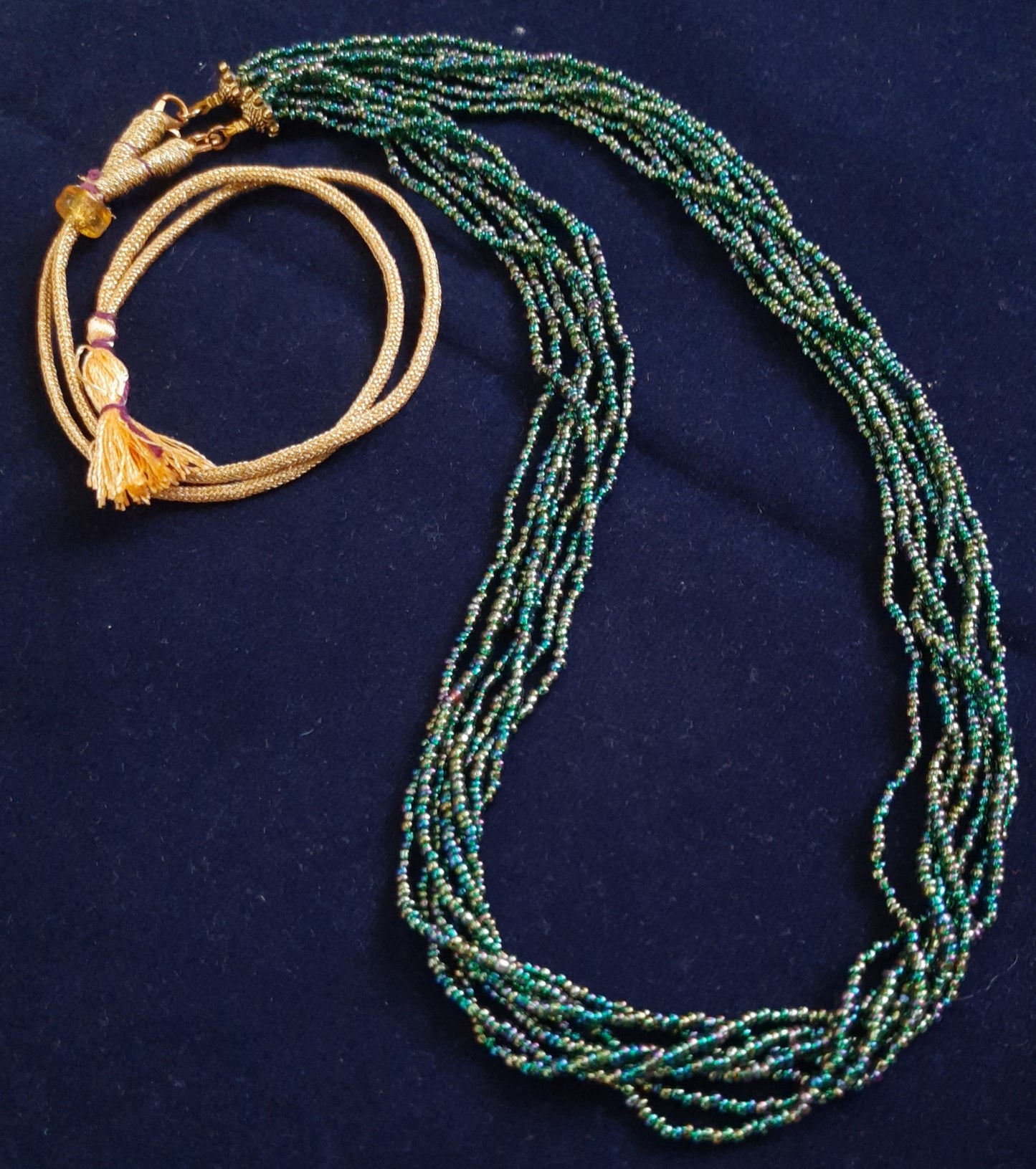 
                  
                    Glimmering green based multicolour multilayered beads mala.
                  
                
