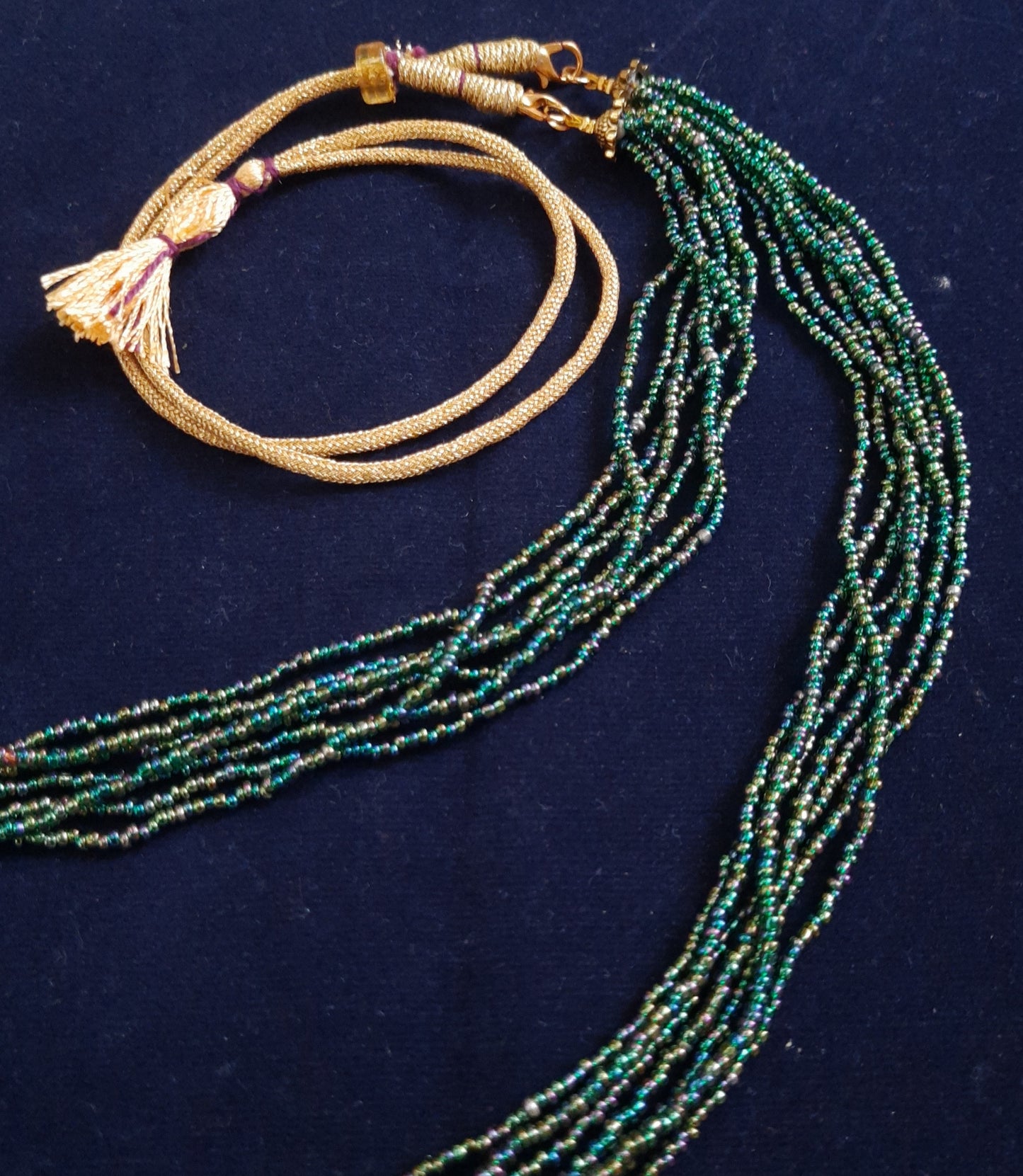
                  
                    Glimmering green based multicolour multilayered beads mala.
                  
                