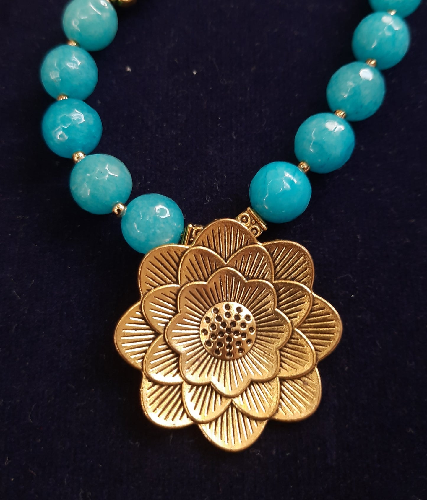 
                  
                    Pretty blue semiprecious agate beads neckwear with golden pendant and matching earrings
                  
                