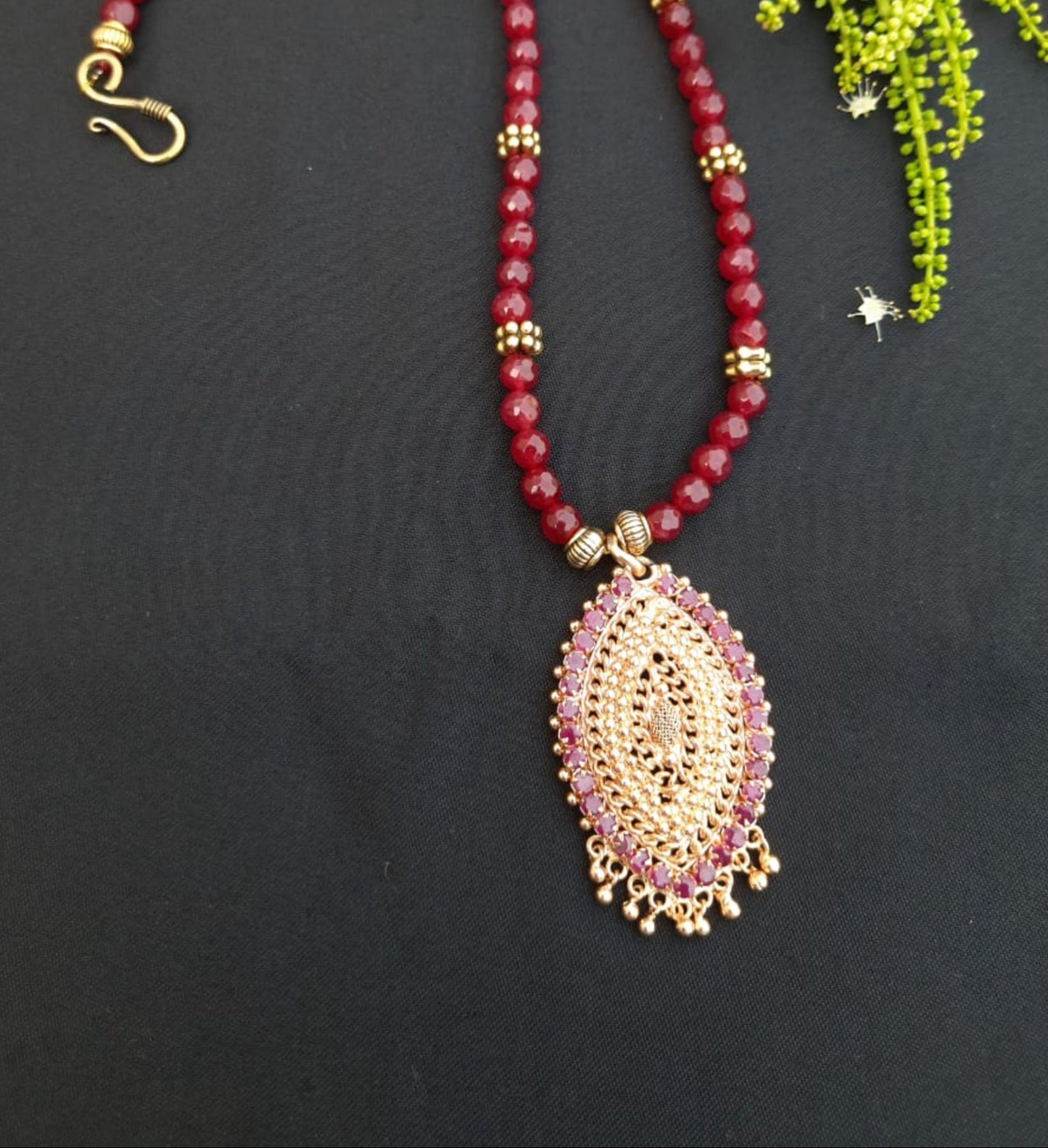 
                  
                    Red agate beads necklace with oxidised gold pendant with red stones.
                  
                