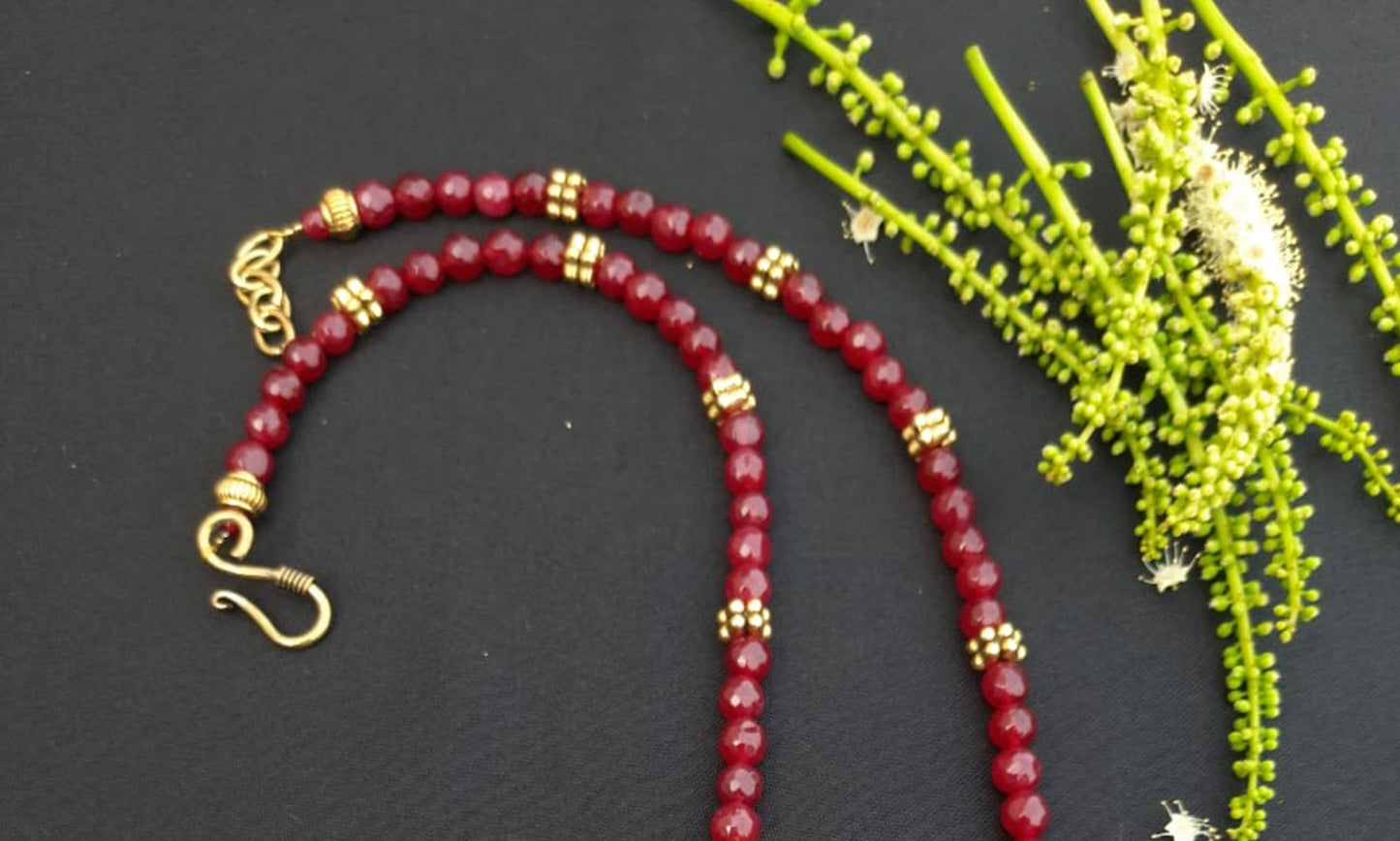 
                  
                    Red agate beads necklace with oxidised gold pendant with red stones.
                  
                