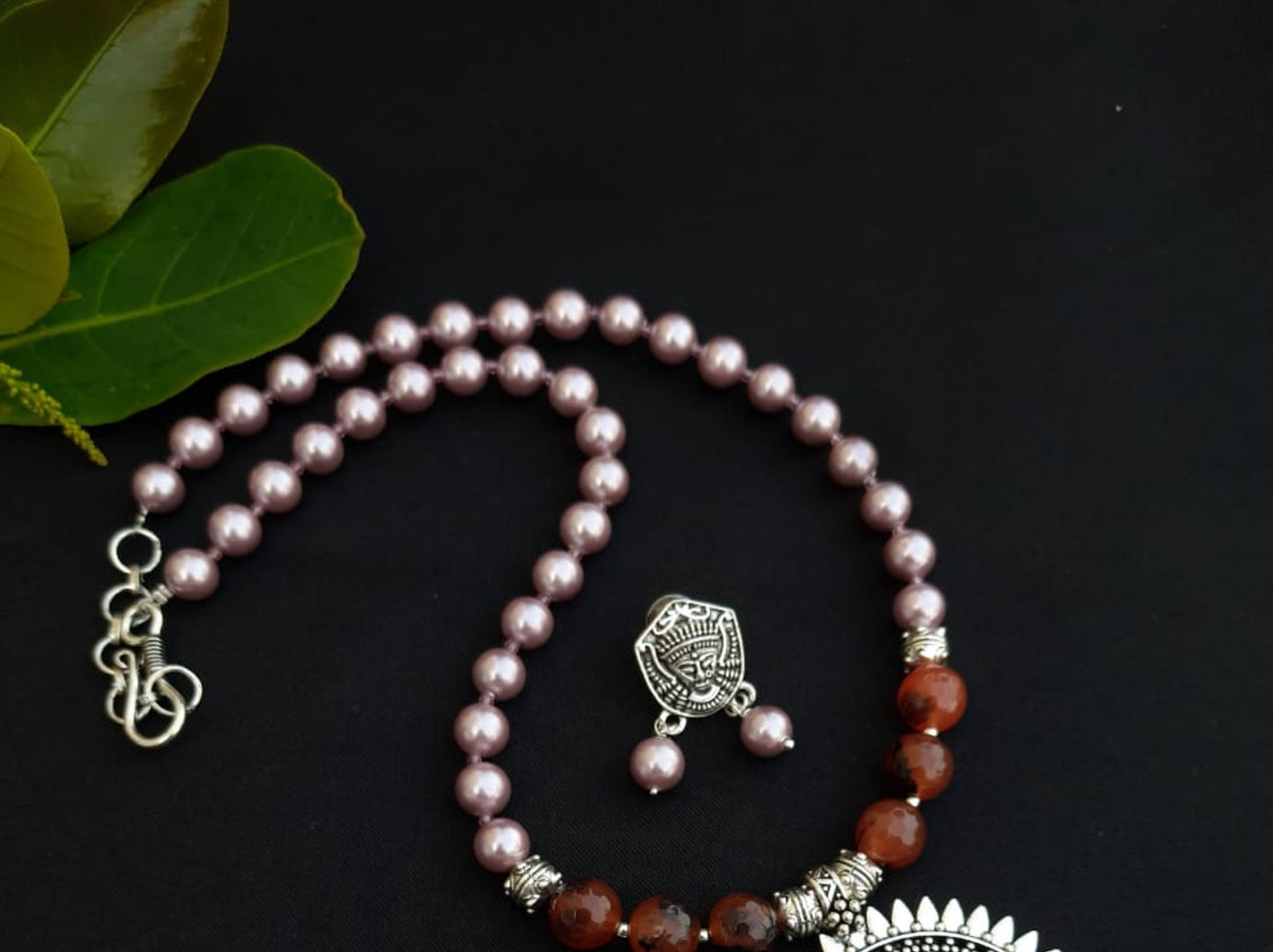 
                  
                    Subtle pink colour shell pearls and brown agate beads necklace with matching pendant and earrings for a classy attire.
                  
                