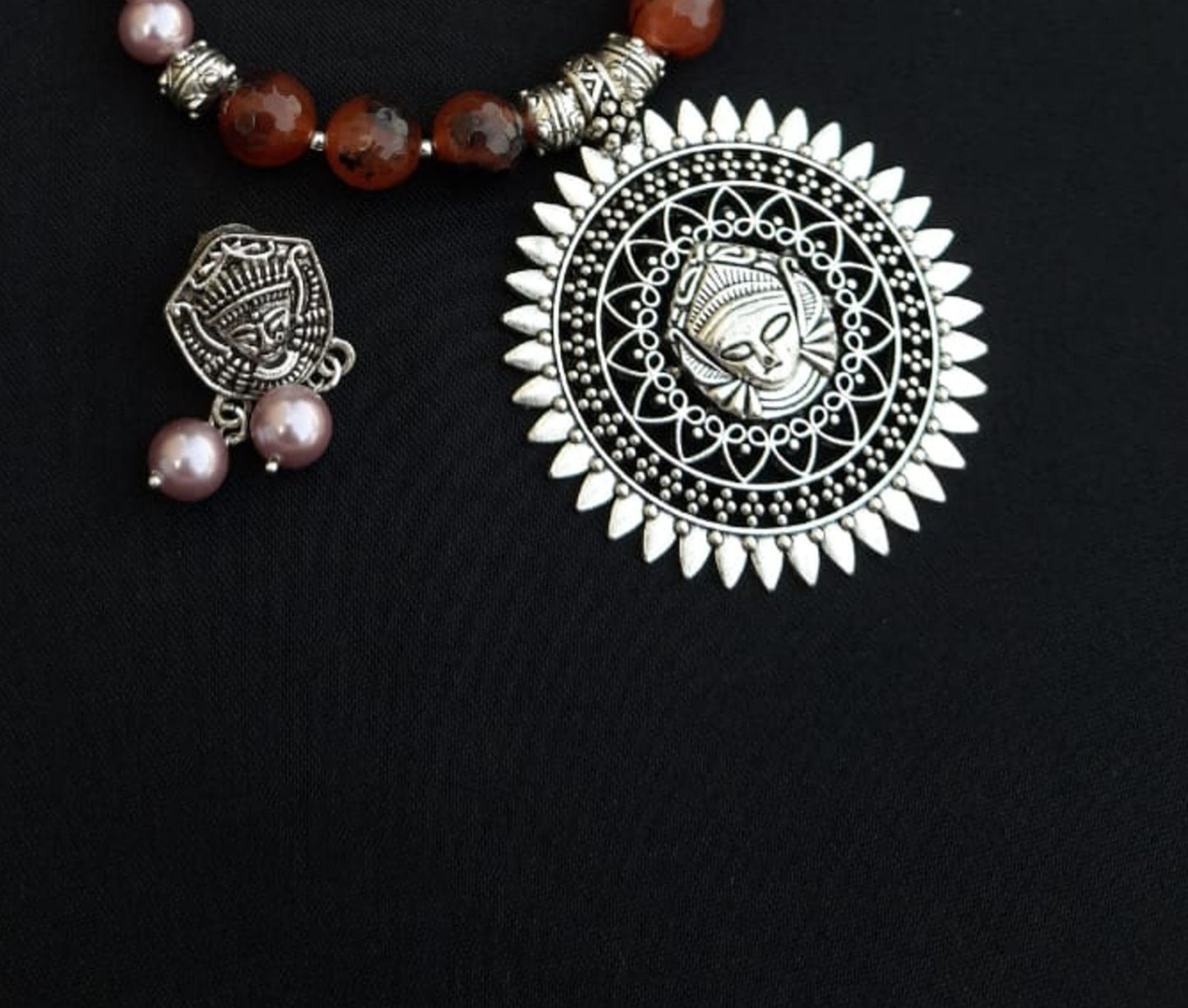
                  
                    Subtle pink colour shell pearls and brown agate beads necklace with matching pendant and earrings for a classy attire.
                  
                
