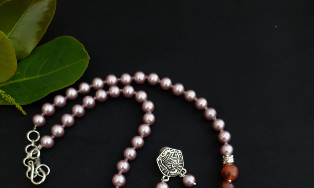
                  
                    Subtle pink colour shell pearls and brown agate beads necklace with matching pendant and earrings for a classy attire.
                  
                