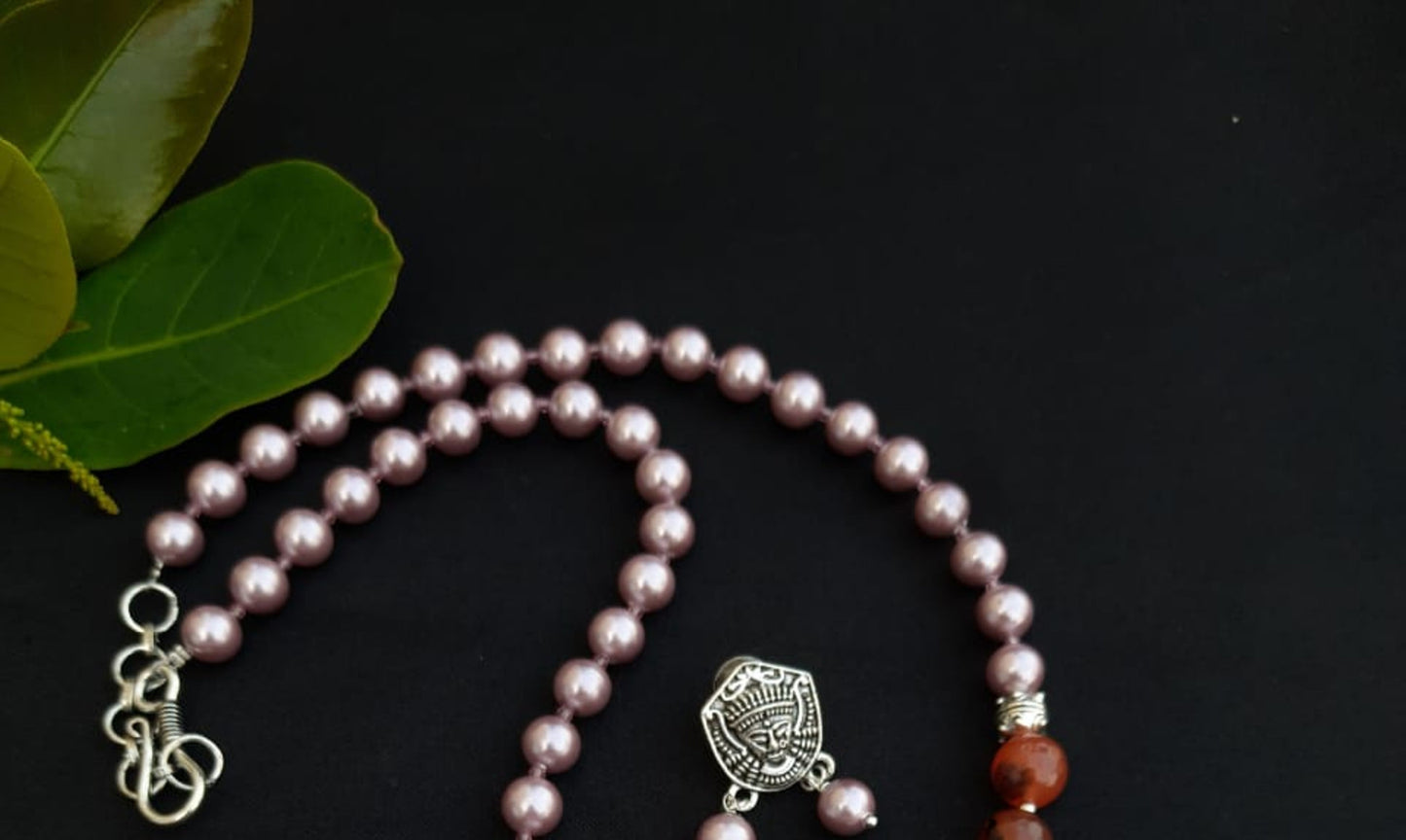 
                  
                    Subtle pink colour shell pearls and brown agate beads necklace with matching pendant and earrings for a classy attire.
                  
                