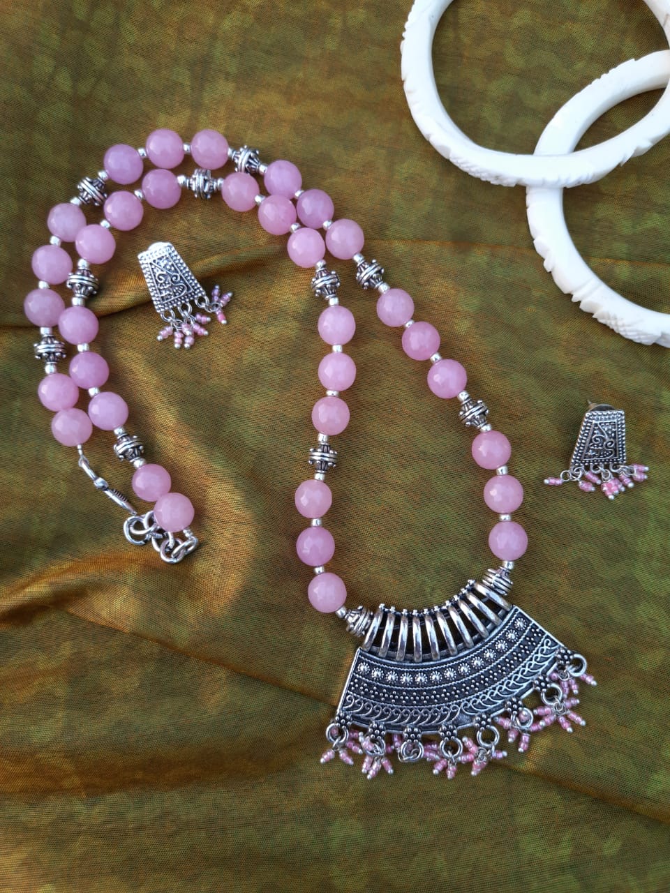 
                  
                    Lovely baby pink agate beads necklace with attractive pendant and earrings.
                  
                