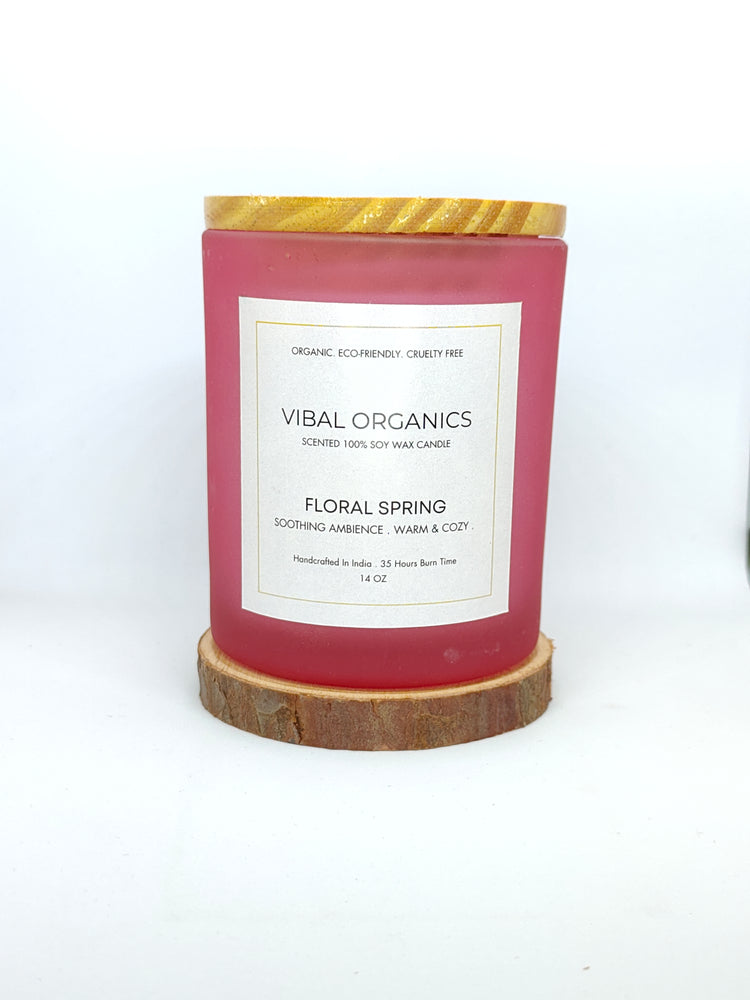 Vibal Organics Floral Spring Scented Candle in a pink glass jar with a wooden lid, labeled as 100% soy wax, organic, eco-friendly, cruelty-free, offering a soothing floral ambience, handcrafted in India with a 35-hour burn time.