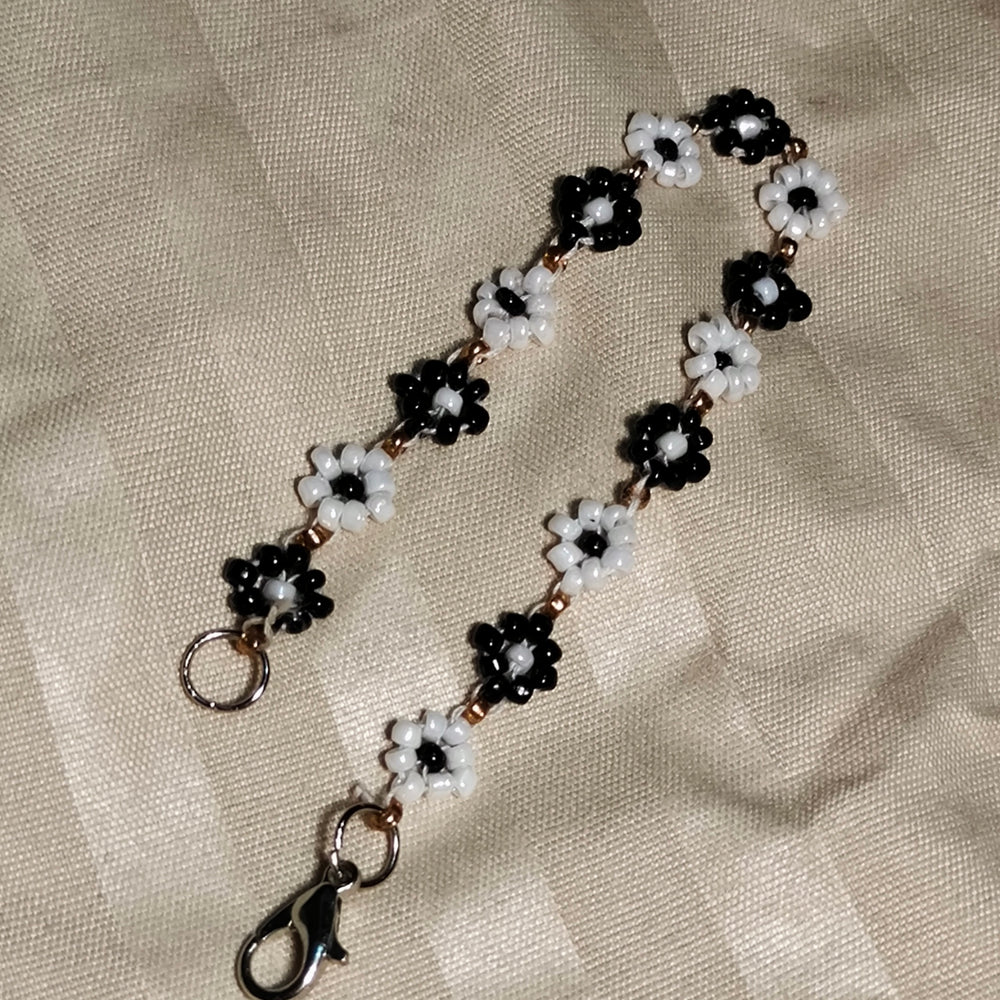 
                  
                    The Enchanted Noir & Ivory Blooms Seed Bead Bracelet
                  
                