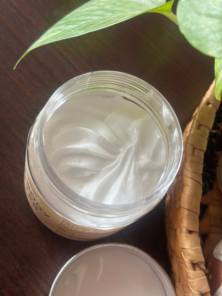 Open jar of rich, creamy Shea Body Butter from my&ma naturals, perfect for dry to extra dry skin, infused with organic Shea Butter, papaya extract, and almond oil.