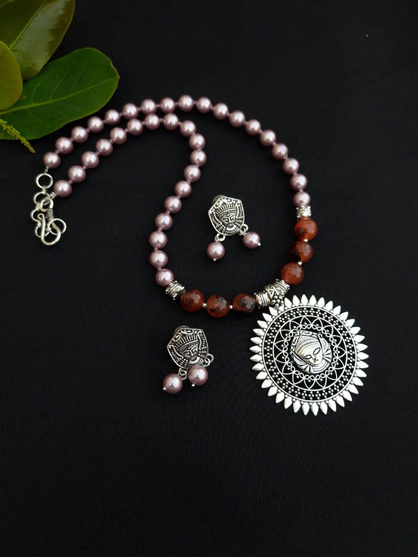 
                  
                    Subtle pink colour shell pearls and brown agate beads necklace with matching pendant and earrings for a classy attire.
                  
                