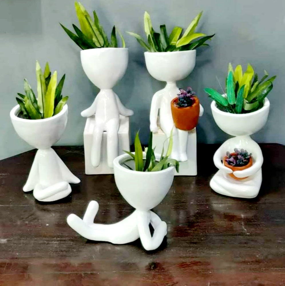 Set of 5 white resin yoga planters and pots, each uniquely shaped in yoga poses, adding a cool, trendy touch to home decor and gardening.