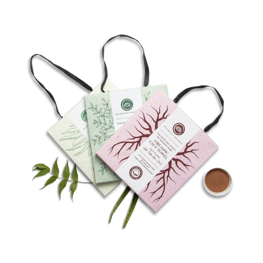 
                  
                    Set of three Kalmic Organic Face Towels in pink, green, and ivory on eco-friendly packaging with ayurvedic herb illustrations.
                  
                